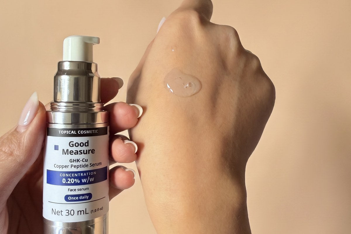 The Good Measure bottle dispensing serum onto a hand